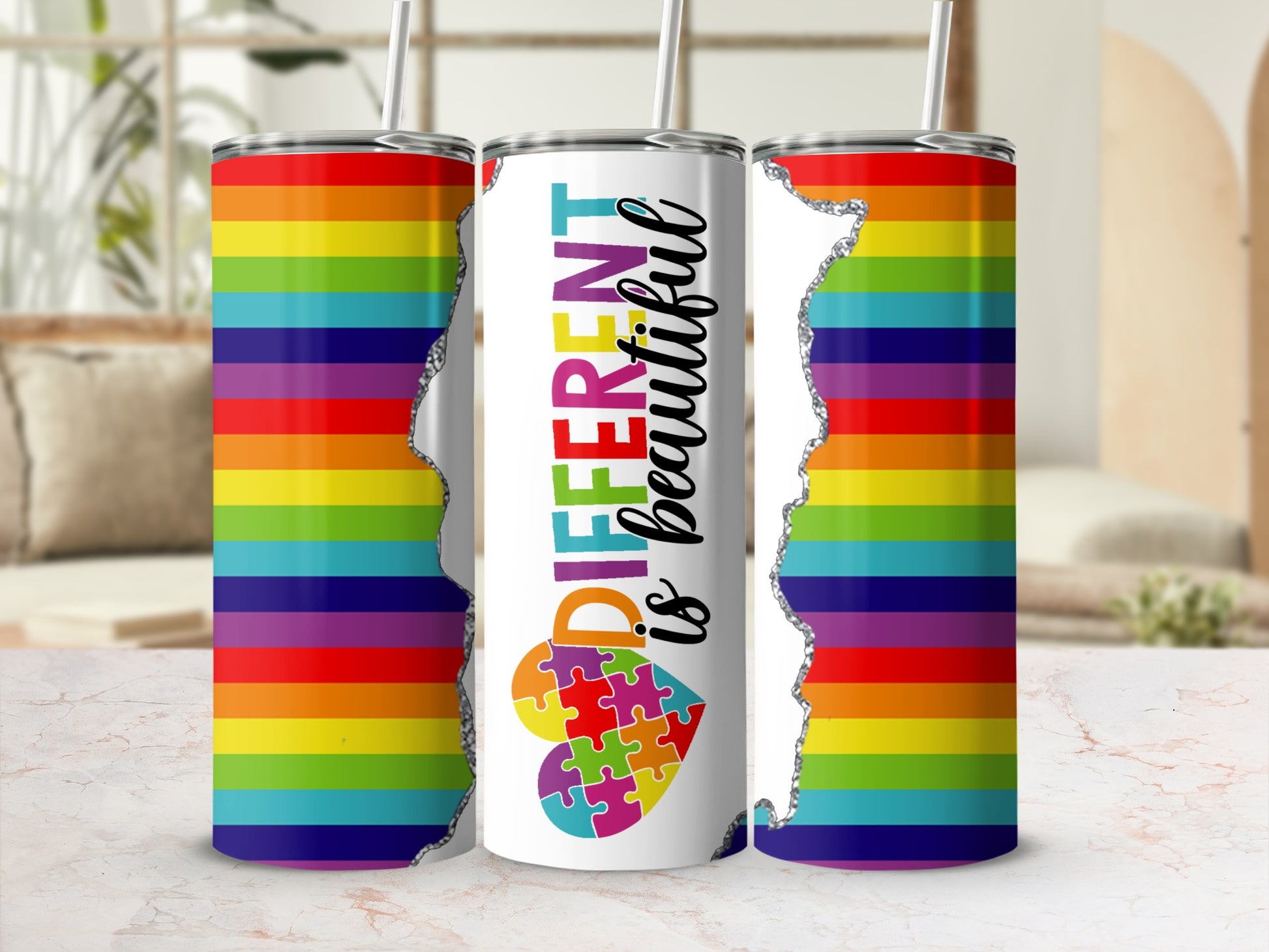 Rainbow striped tumbler with "Different is beautiful" and puzzle pieces.