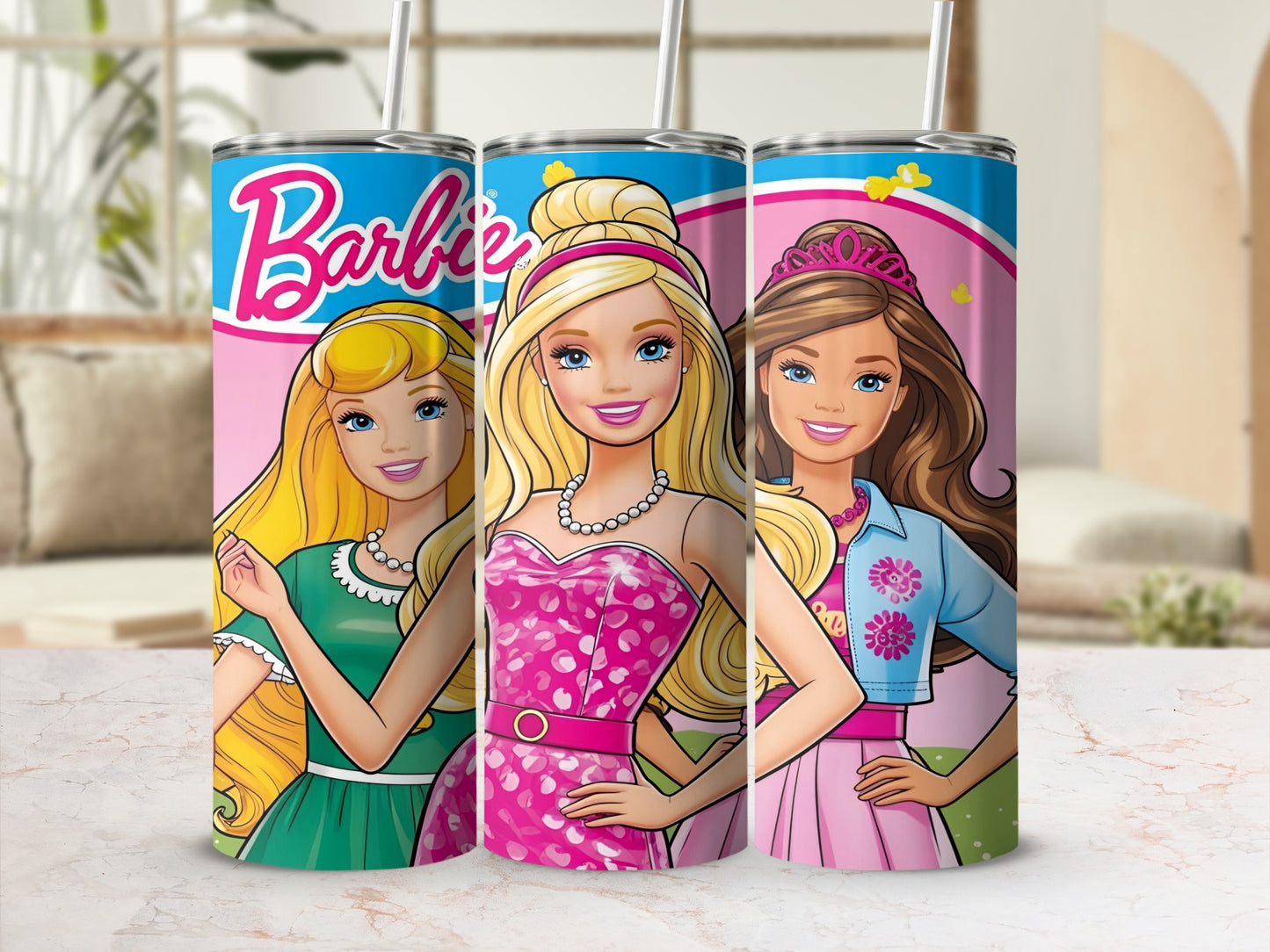 Three Barbie tumblers with colorful designs and straws in a display setting.