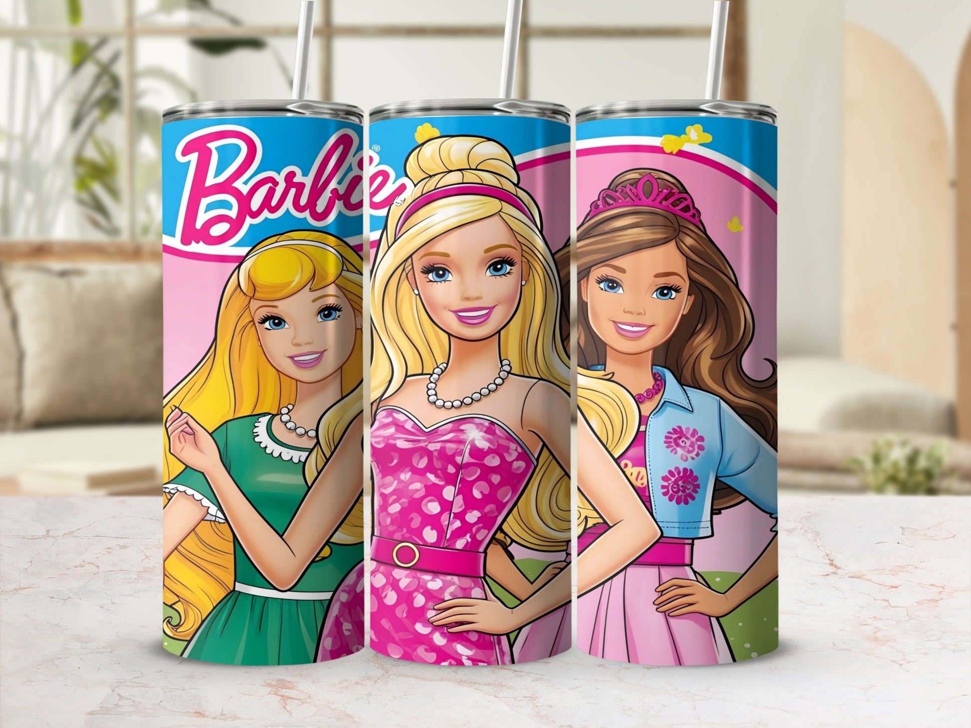 Three Barbie tumblers with colorful designs and straws in a display setting.
