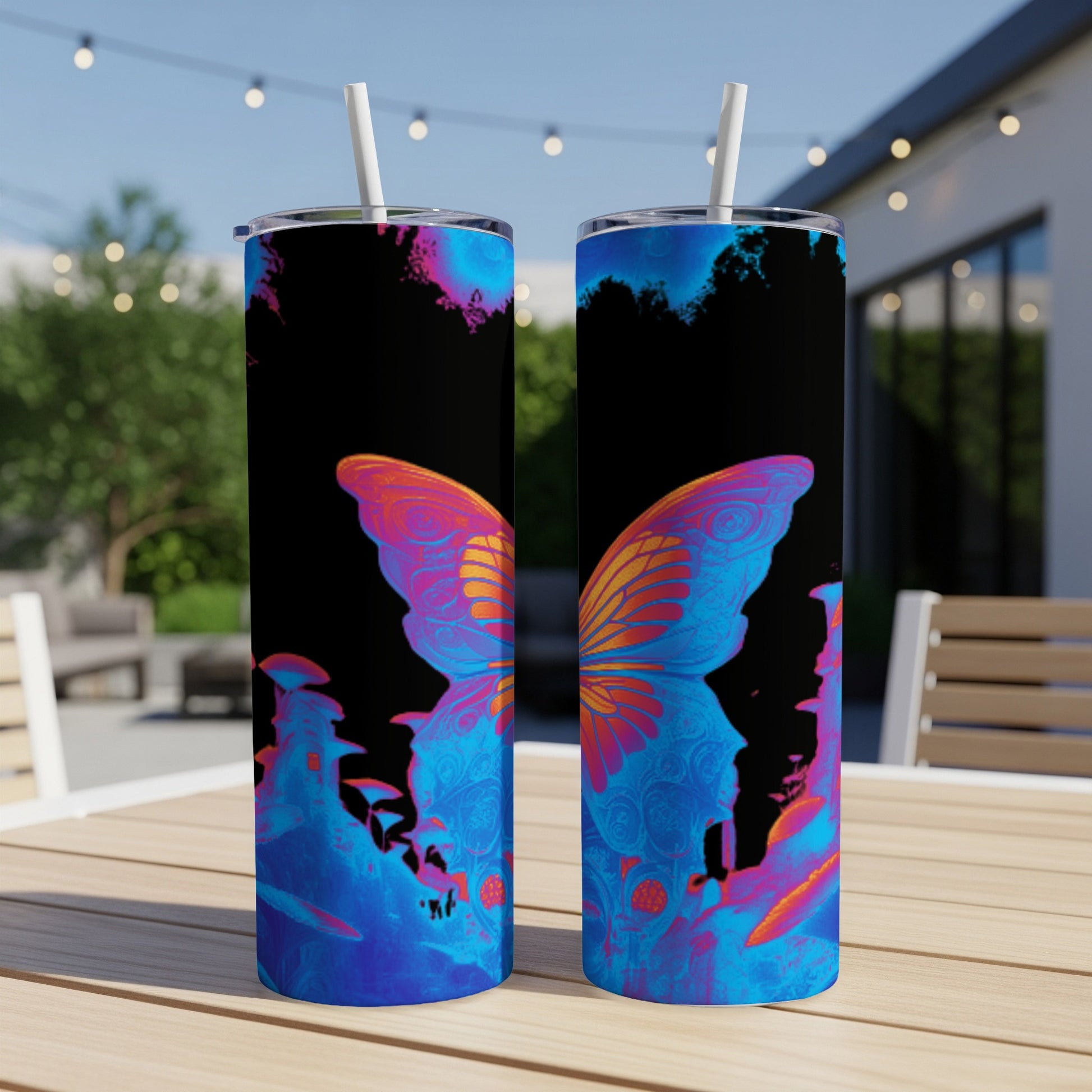 Two blue and orange butterfly tumblers with straws on a table.