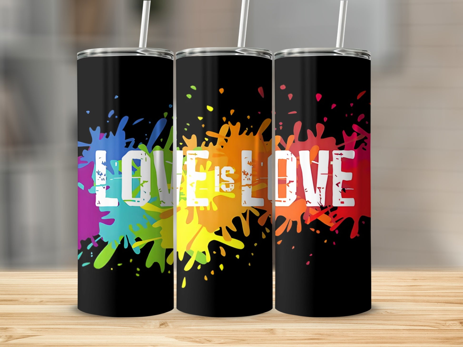 Three black tumblers with "LOVE IS LOVE" in colorful paint splatters.