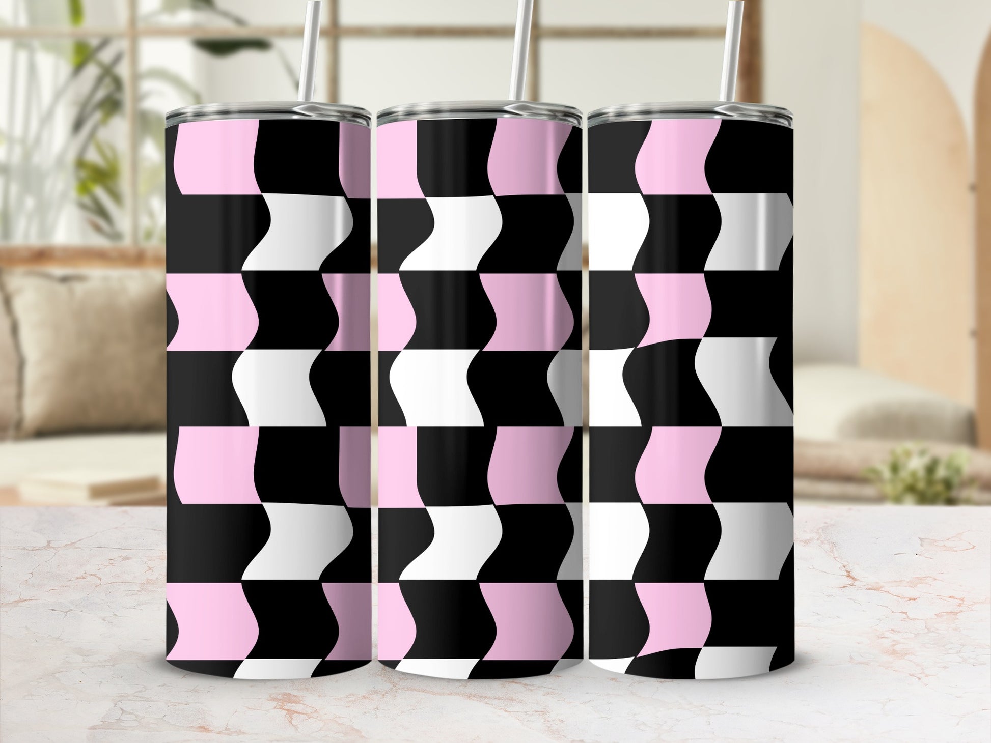 Three pink, black, and white checkered pattern tumblers with straws.