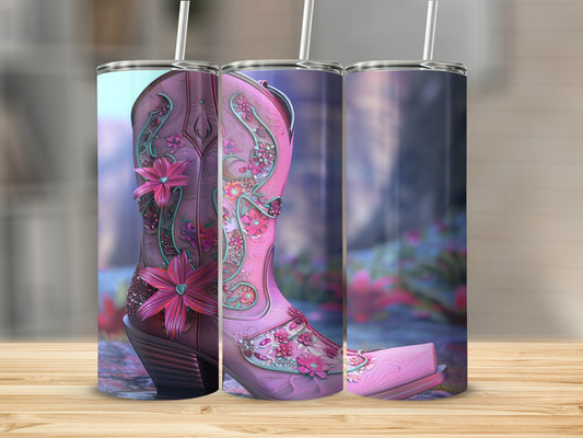 Pink cowboy boot with floral embellishments on a wooden surface.