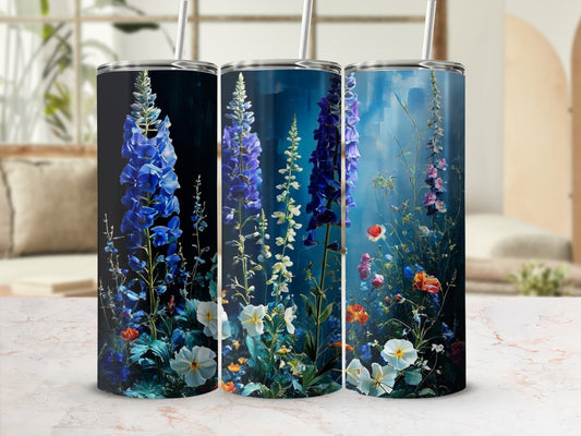 Three tumblers with floral designs, featuring blue delphiniums and colorful wildflowers.
