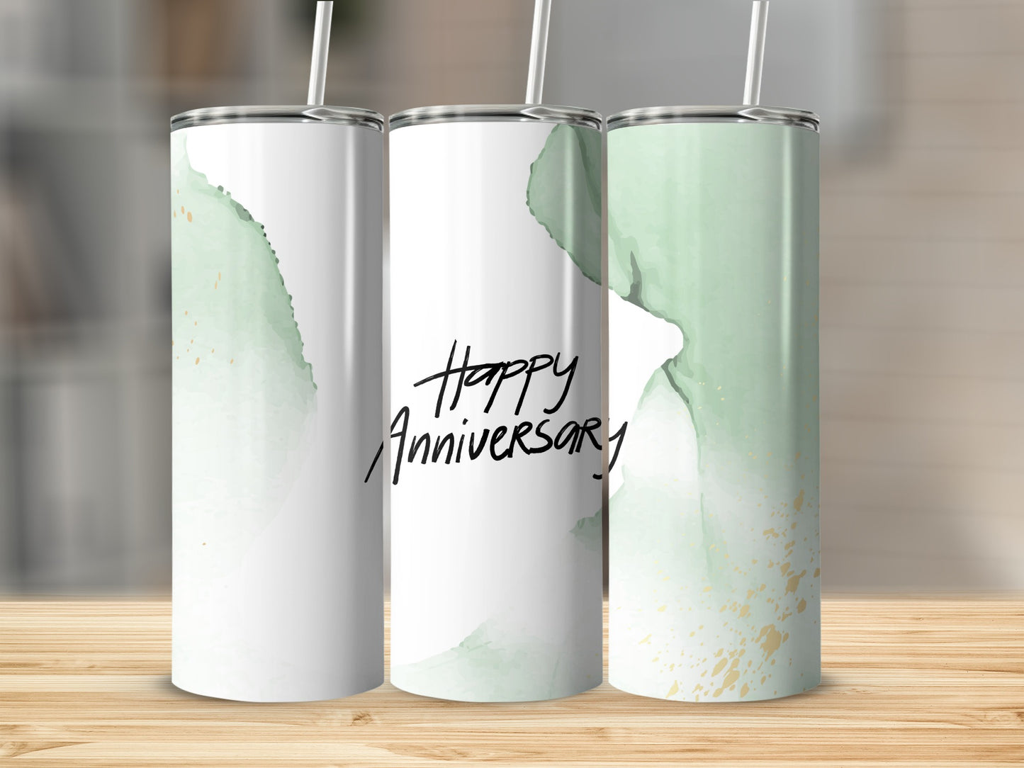 Three tumblers with green watercolor and gold accents, one with "Happy Anniversary."
