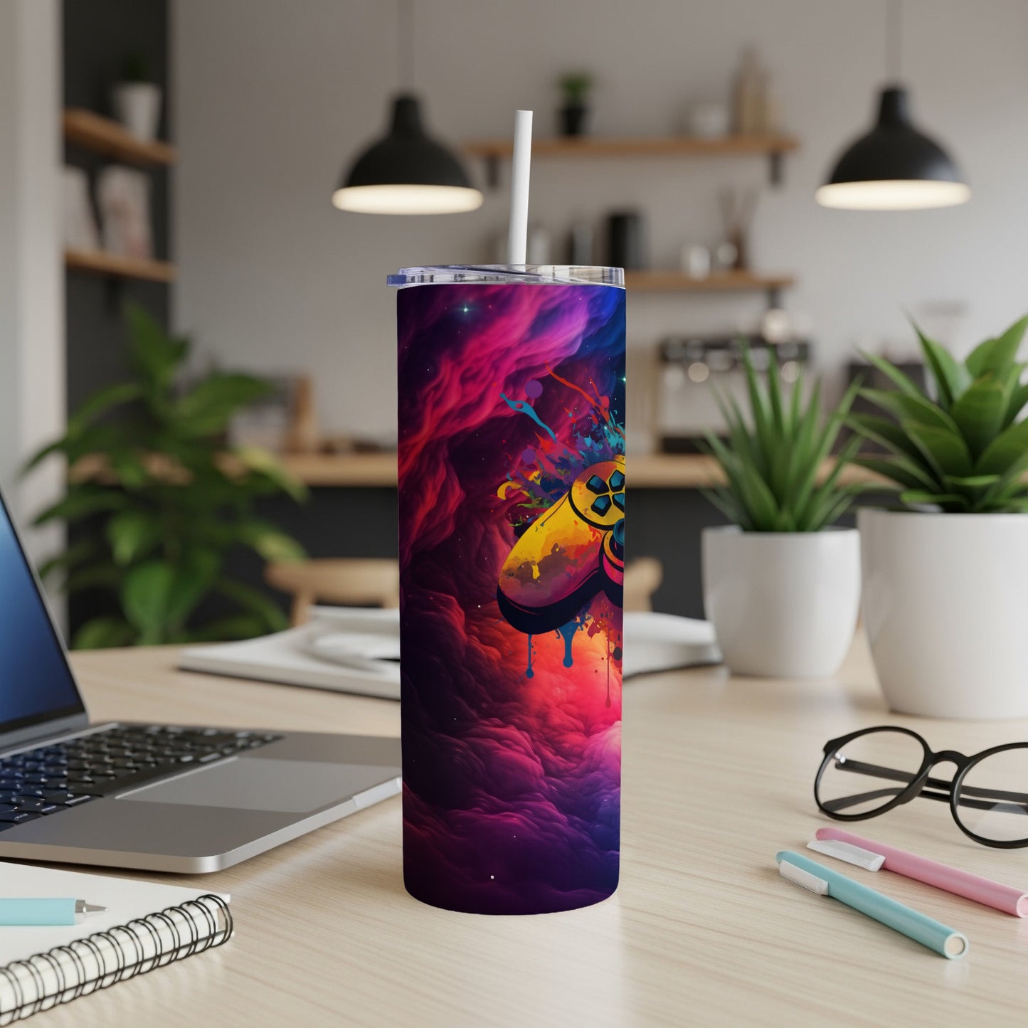 Gaming controller design on a colorful, abstract, insulated tumbler.