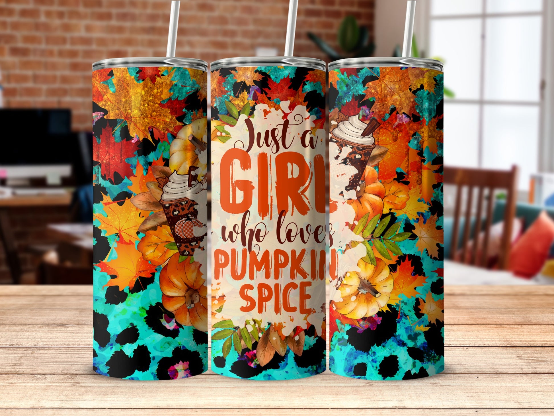 Tumbler with "Just a girl who loves pumpkin spice" text and fall leaves.