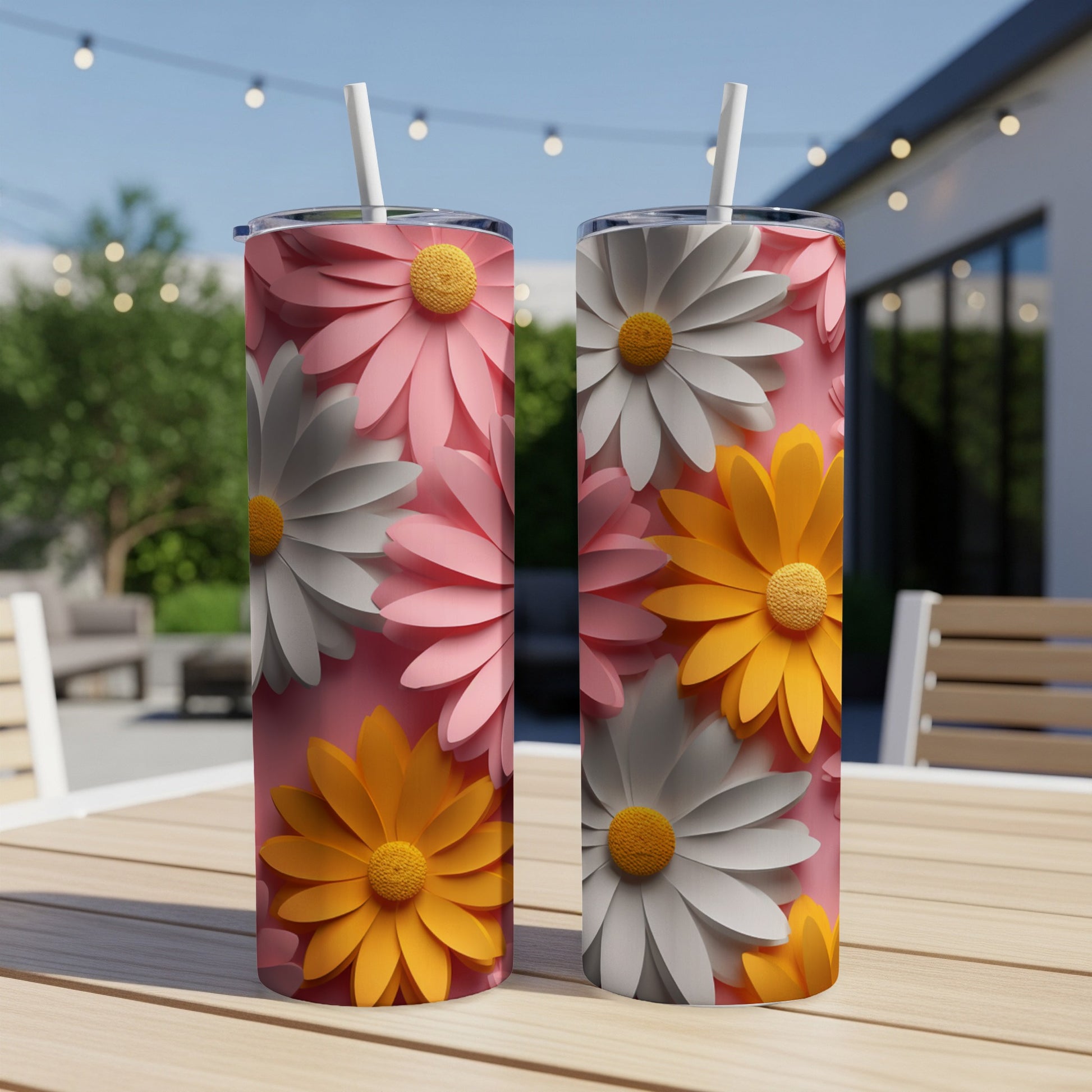 Two pink and orange floral pattern tumblers on a table.