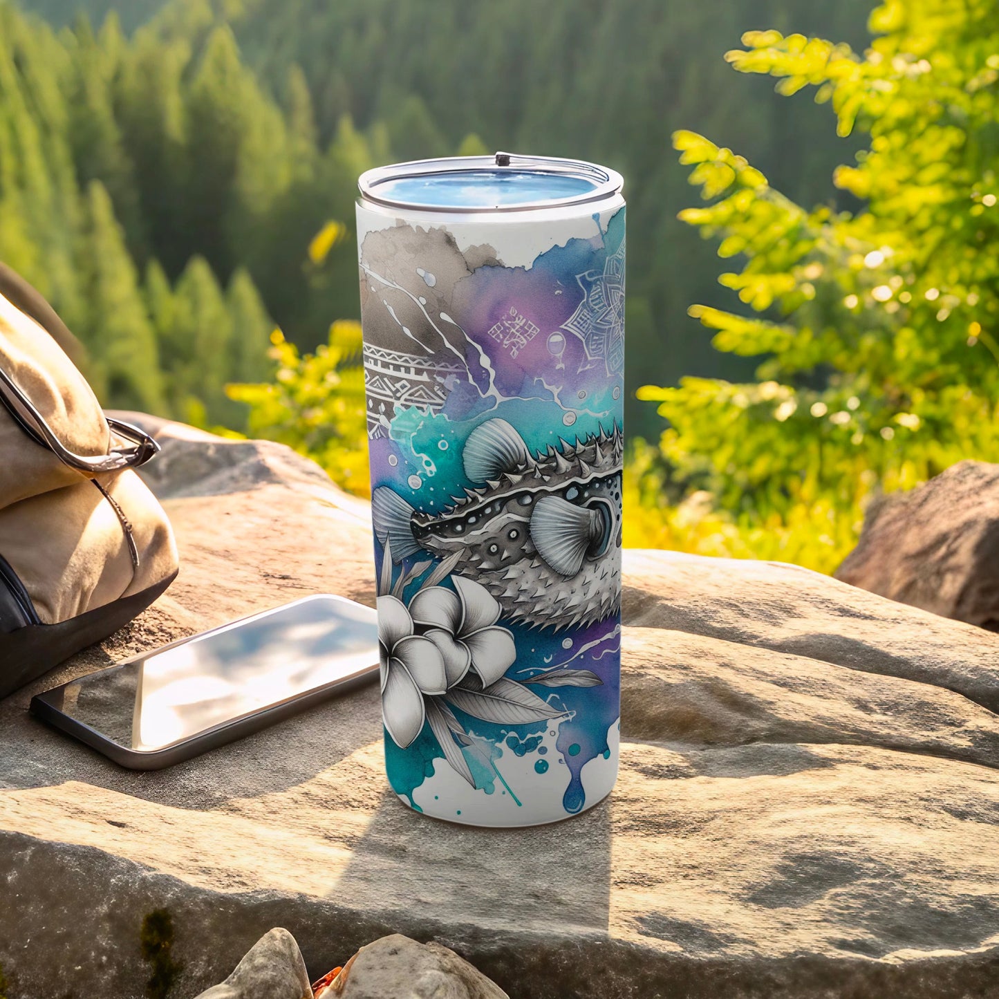 Pufferfish and floral art on a blue and purple gradient tumbler.