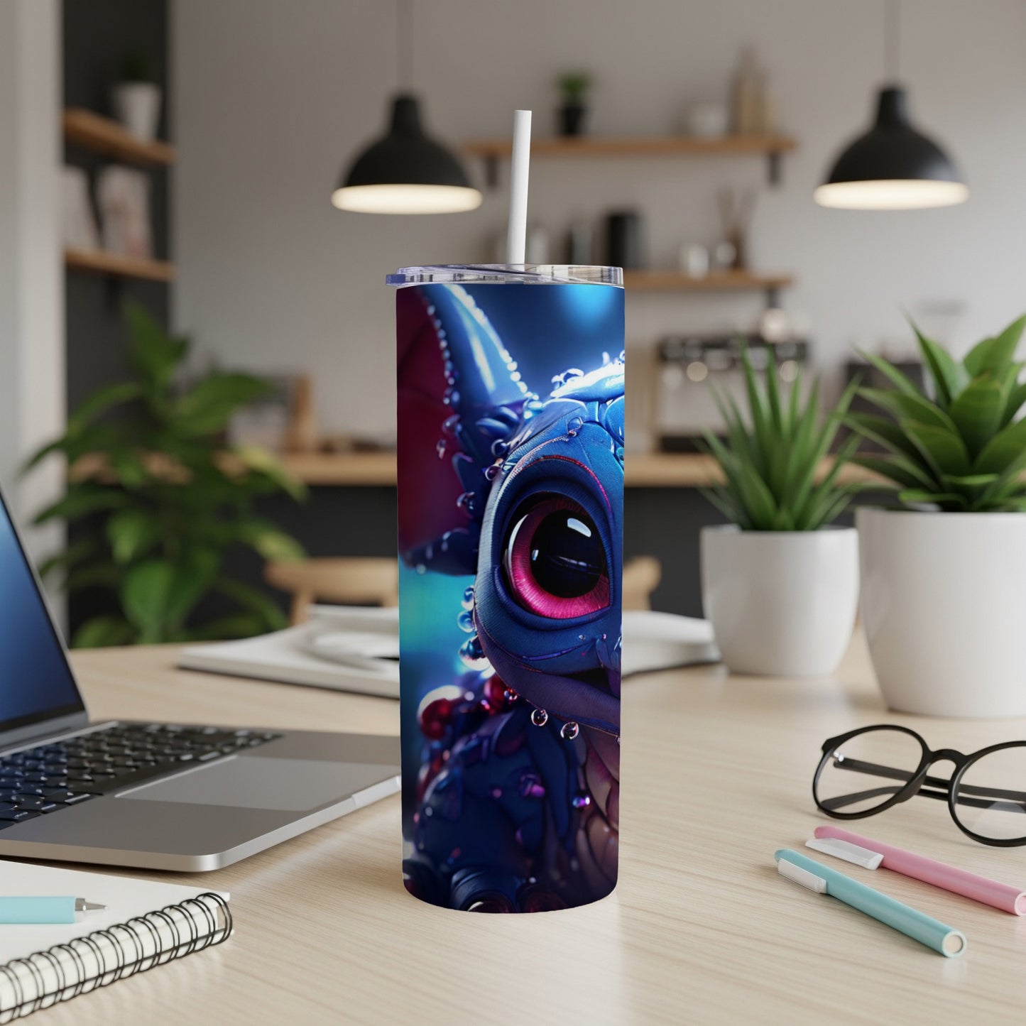 Blue dragon character on a stainless steel tumbler with a straw.