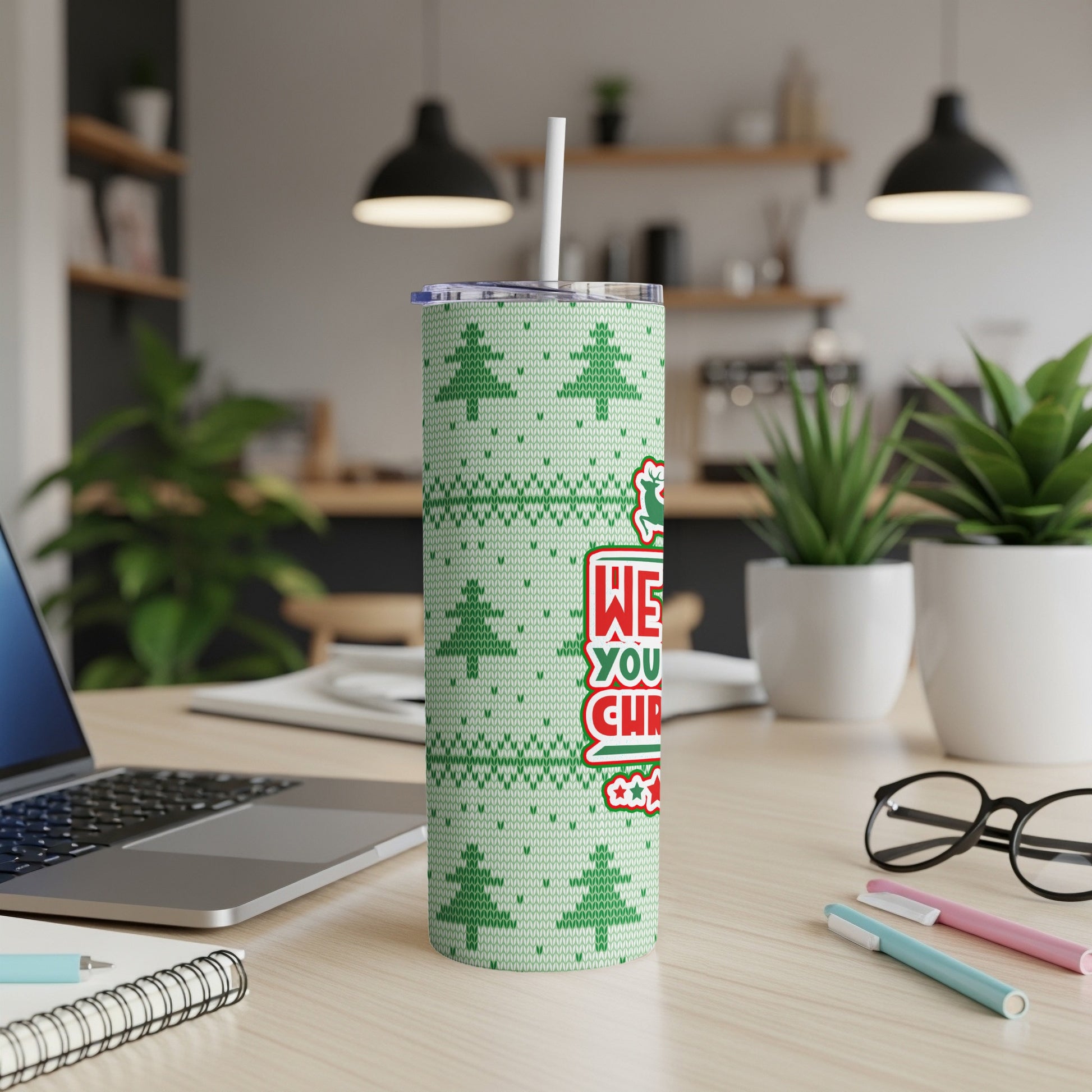 Green Christmas tumbler with "Merry Christmas" text and festive tree pattern.