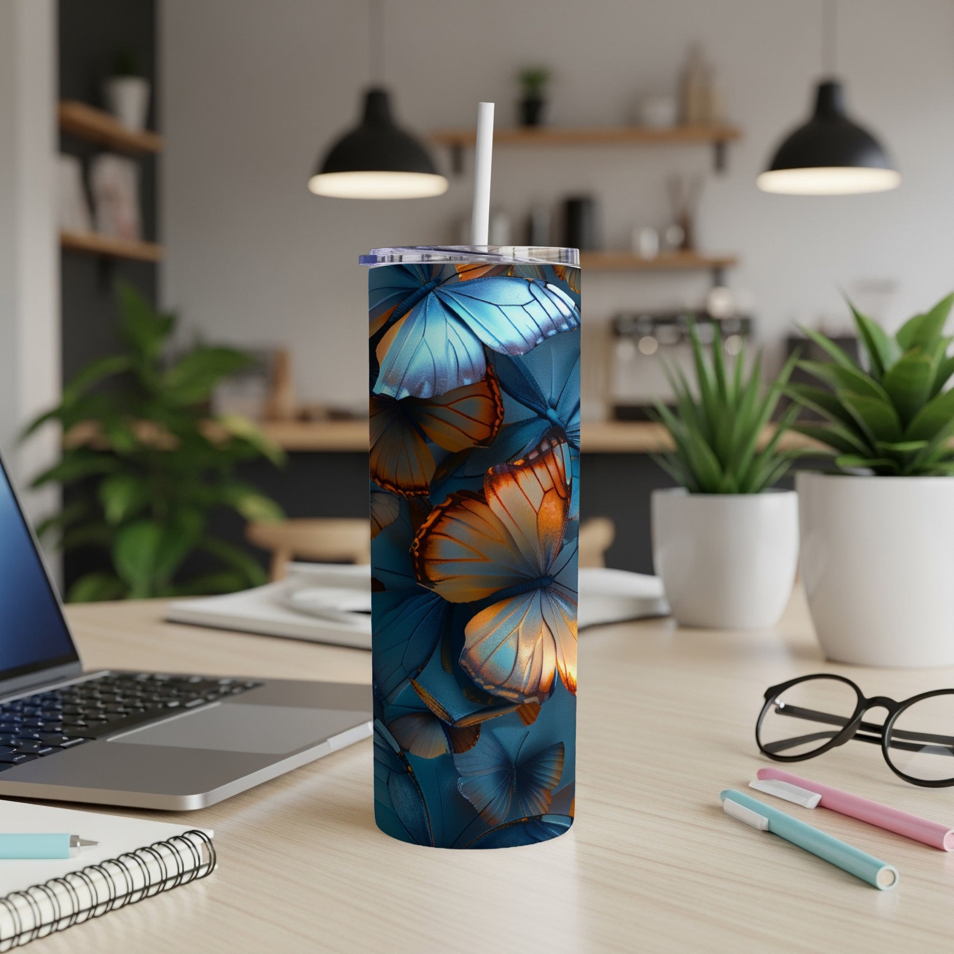 Blue and orange butterflies cover a white tumbler with a straw.