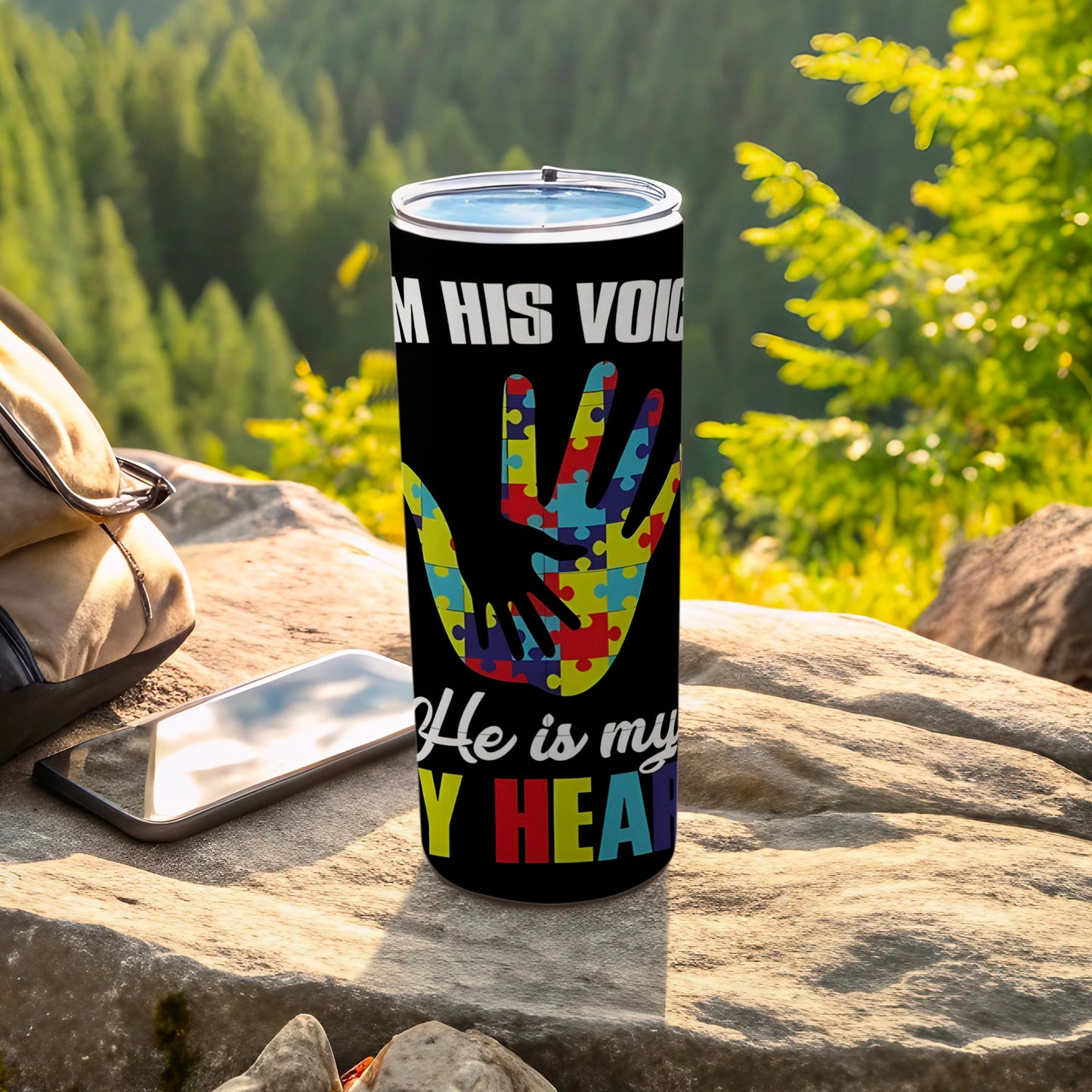 Tumbler with autism puzzle hand and text "I AM HIS VOICE" and "He is my HEART".