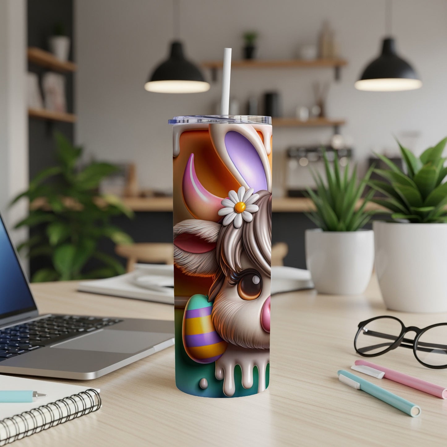 Easter bunny cow tumbler with straw, on a desk.