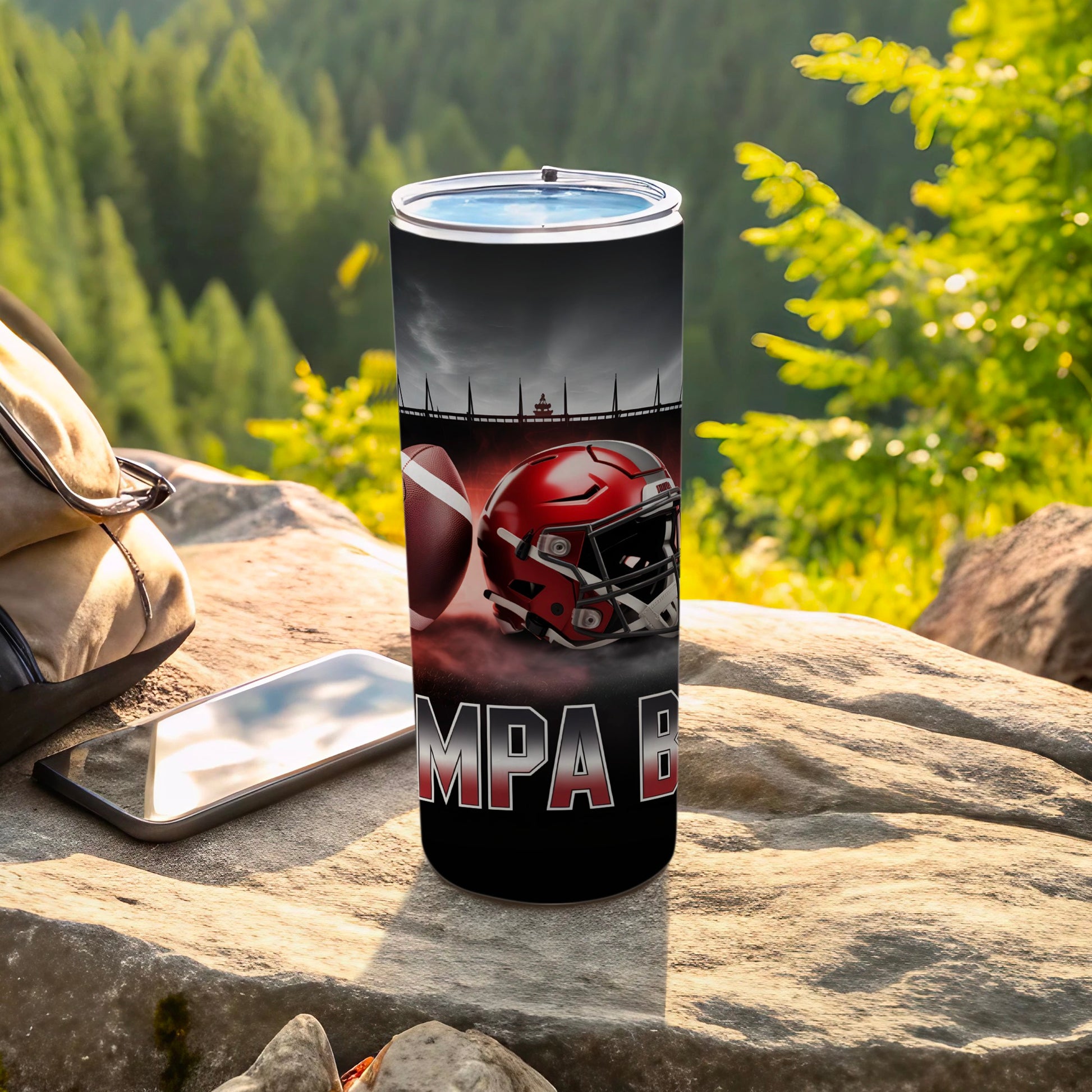 Football helmet and ball on Tampa Bay themed tumbler with outdoor background.
