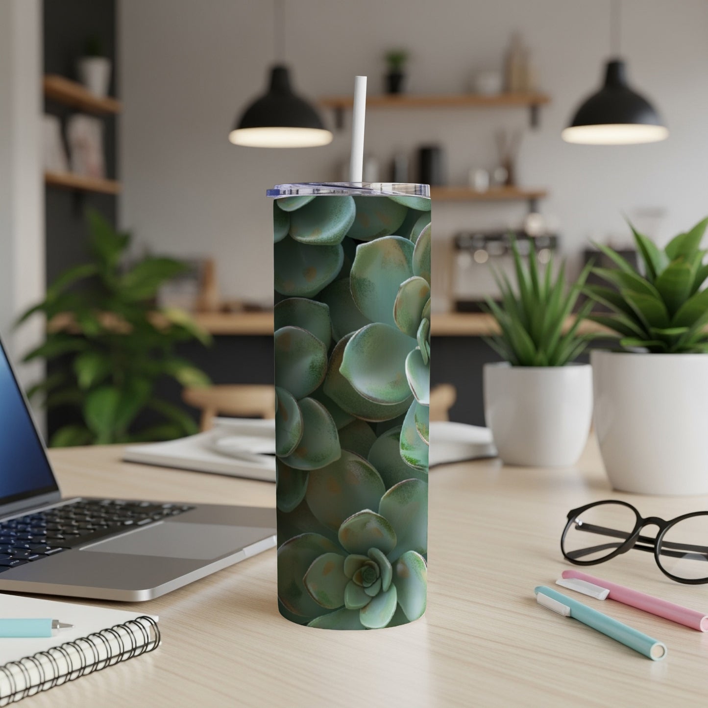 Succulent plant pattern on a white tumbler with a straw.