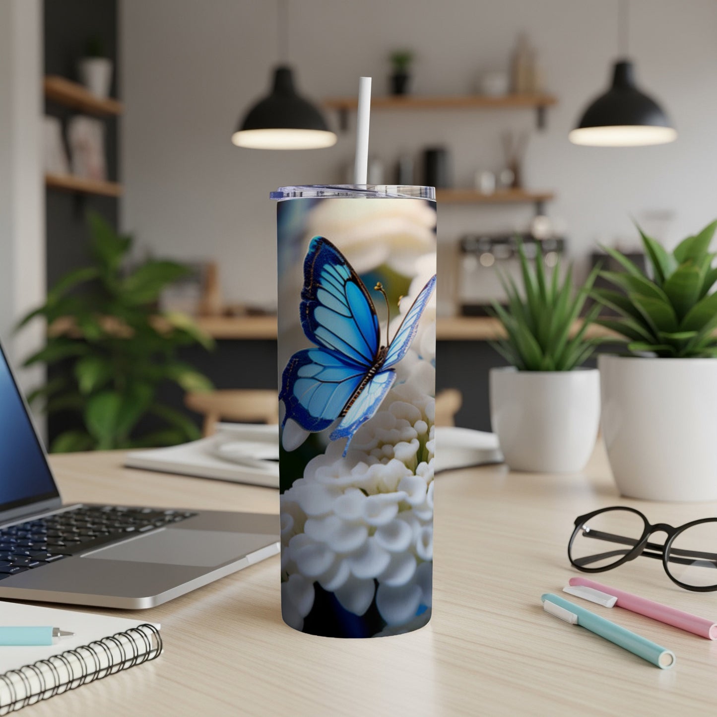Blue butterfly on white flowers on a skinny tumbler.