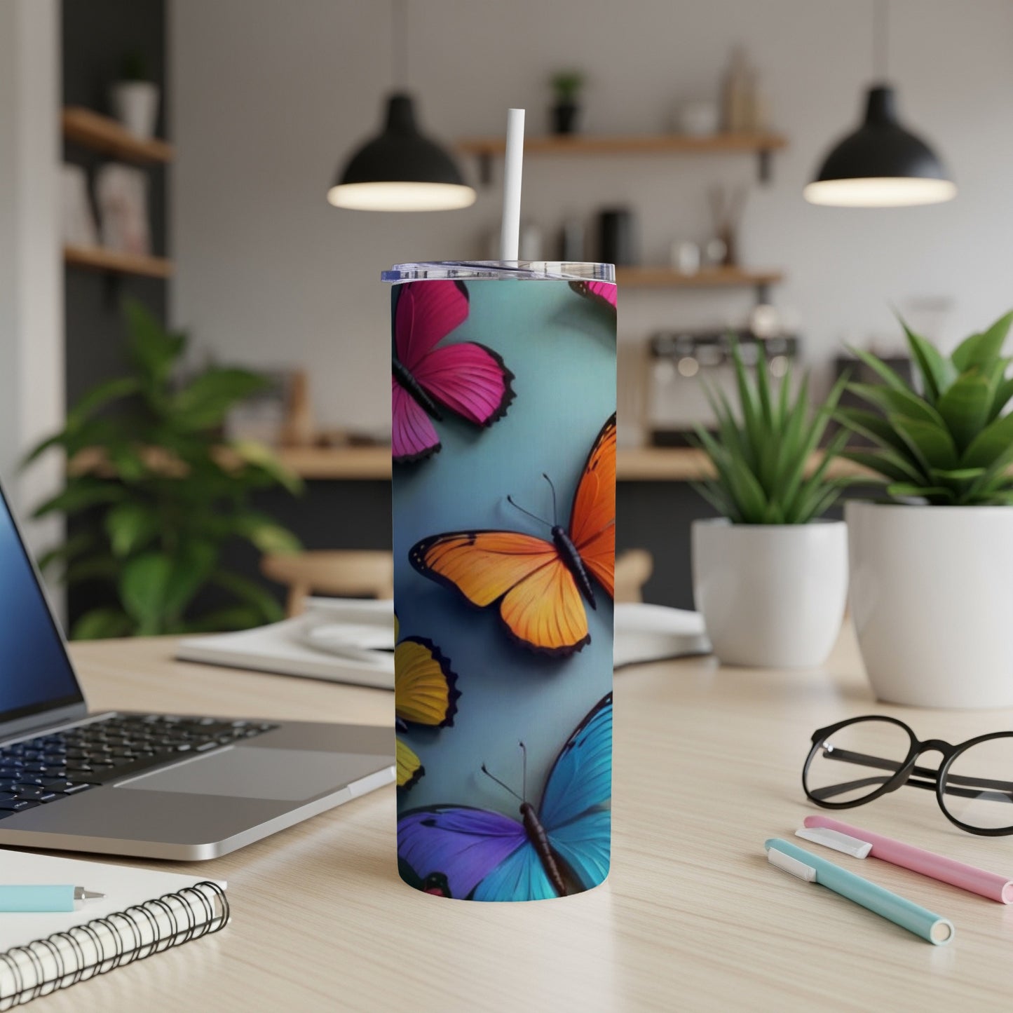 Tall tumbler with colorful butterflies on a blue background.