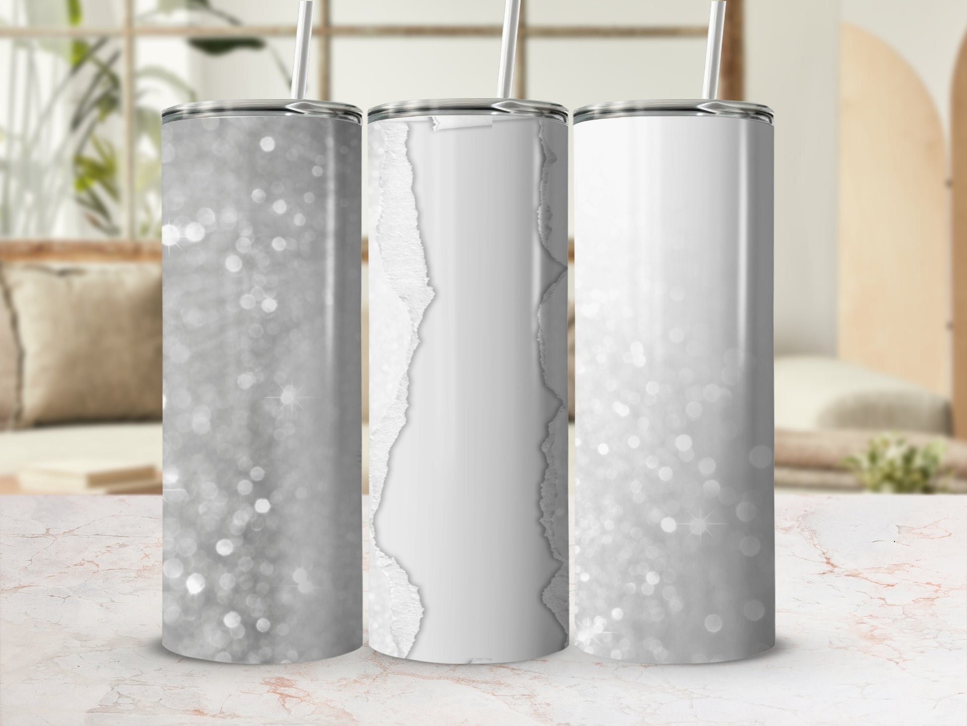 Three glittery tumblers with white torn paper accents and straws.