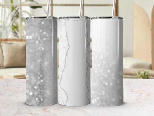 Three glittery tumblers with white torn paper accents and straws.