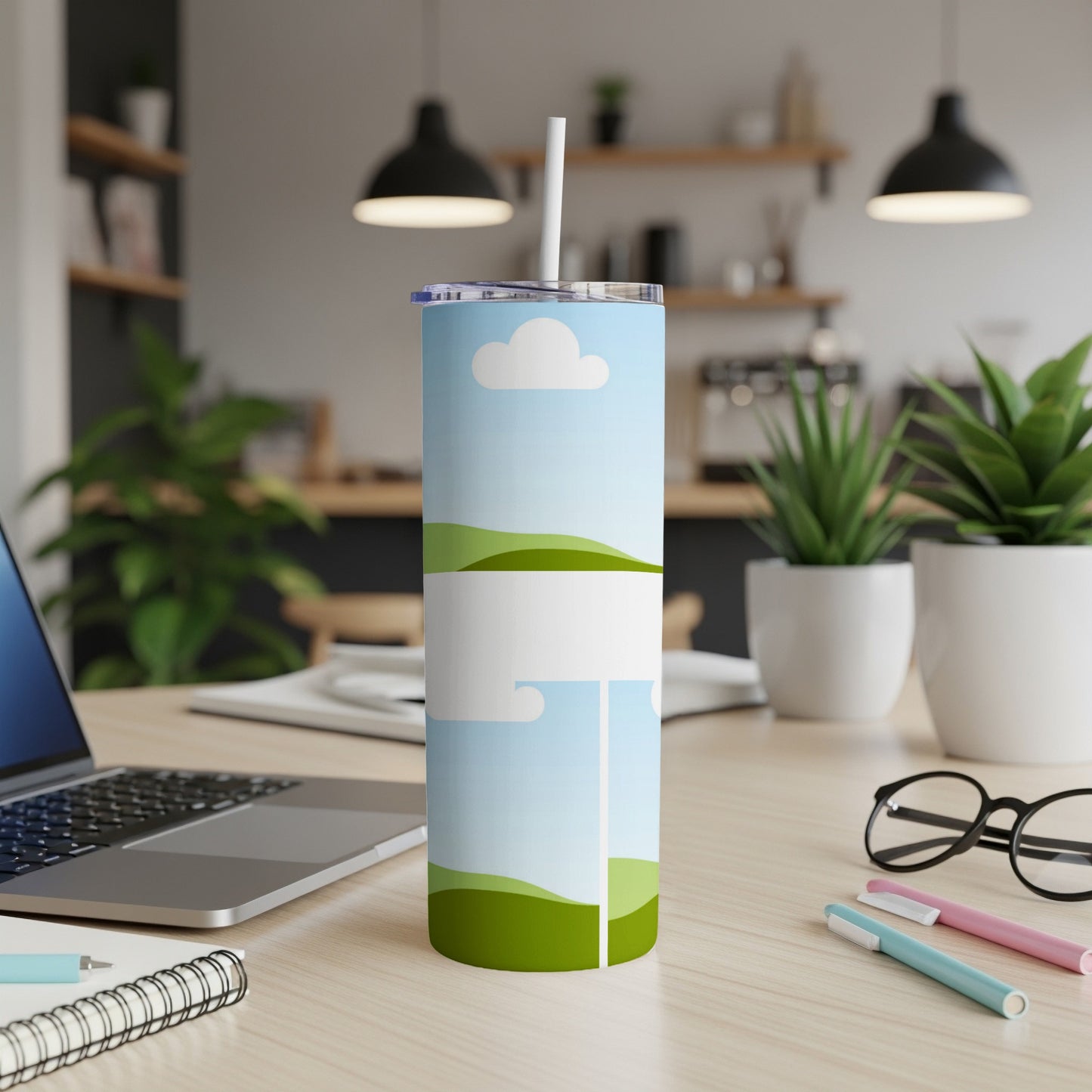 Tumbler with a pastel landscape design featuring clouds and rolling green hills.