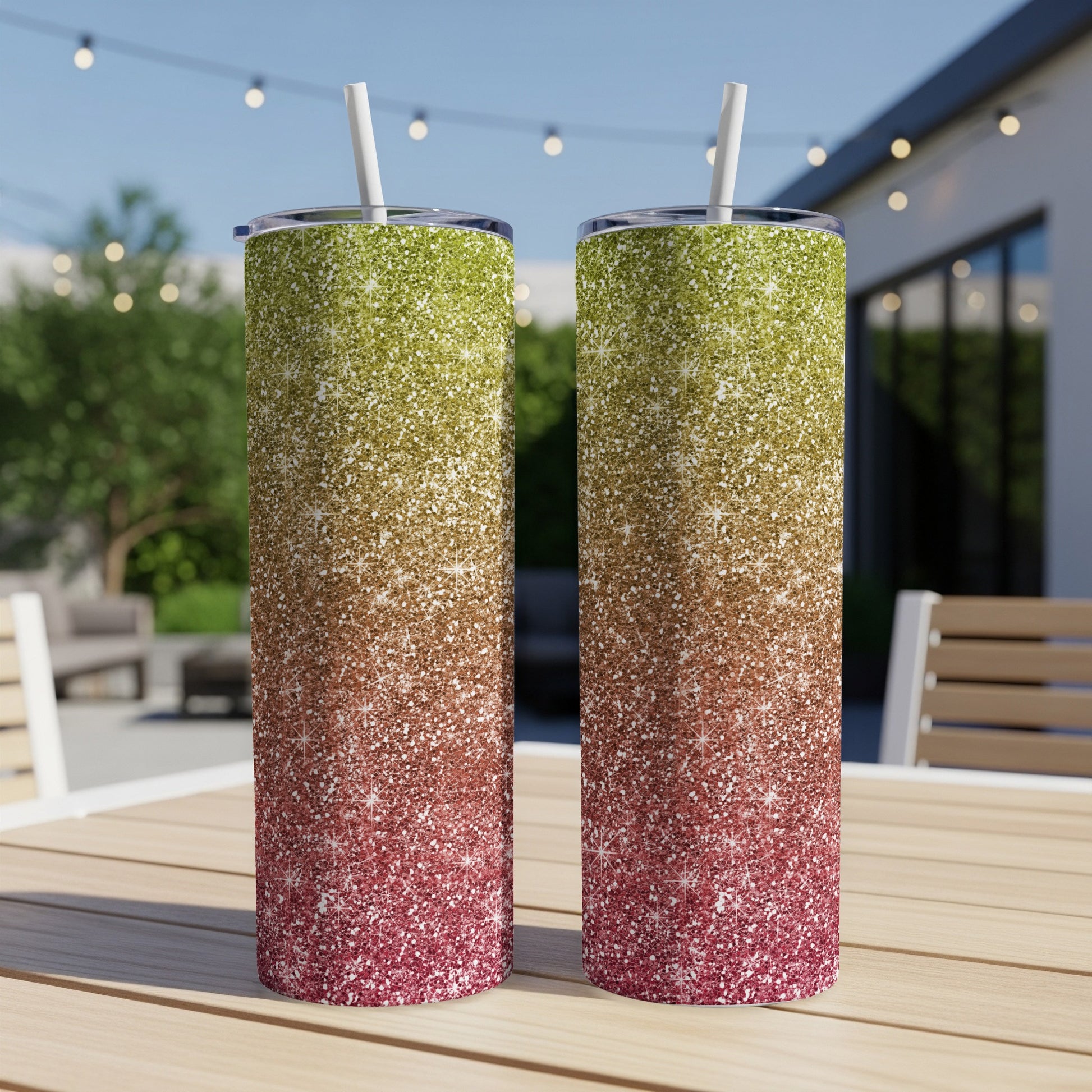 Two glitter tumblers with straws display a gradient of green, brown, and red.