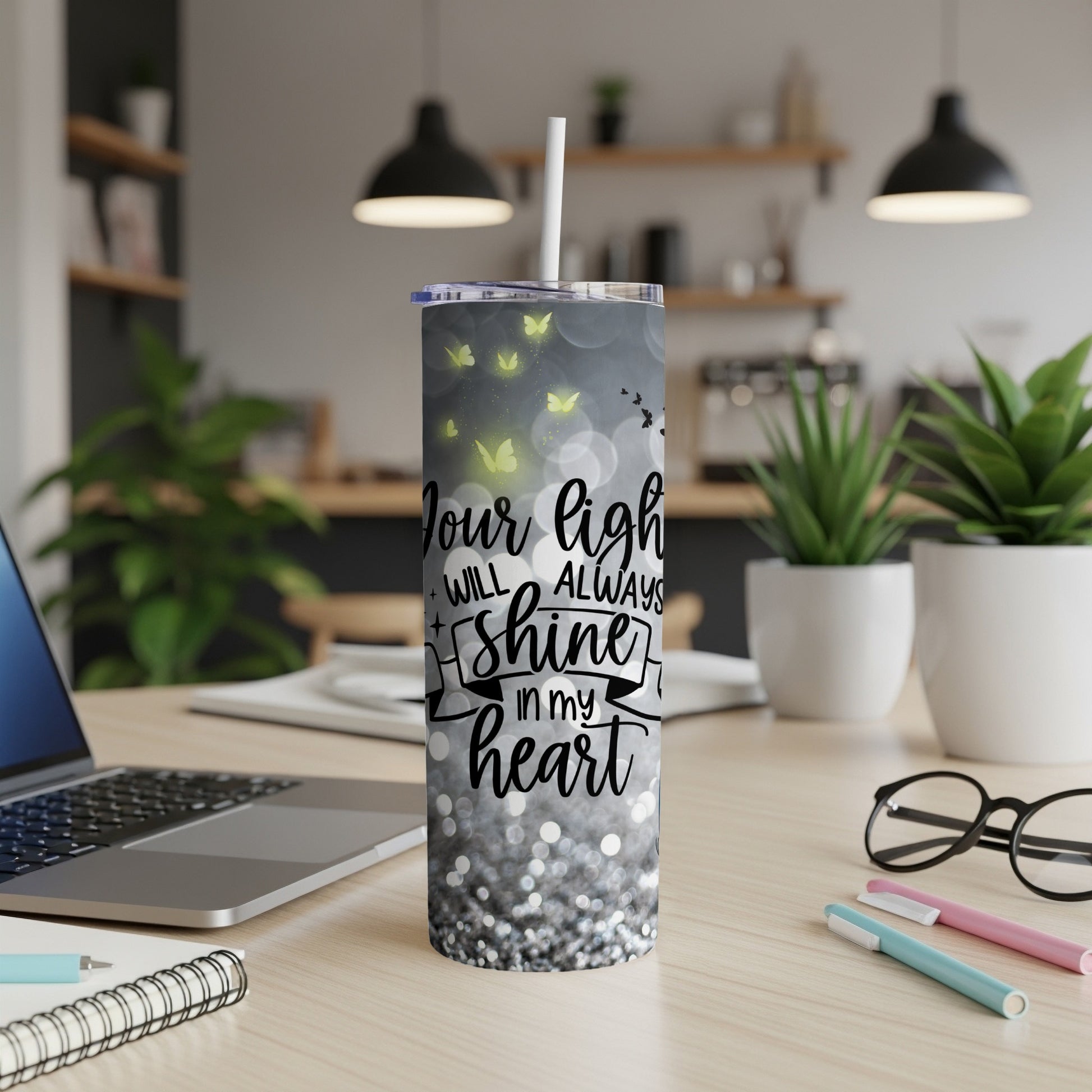 Tall tumbler with "Your light will always shine in my heart" text and butterflies.