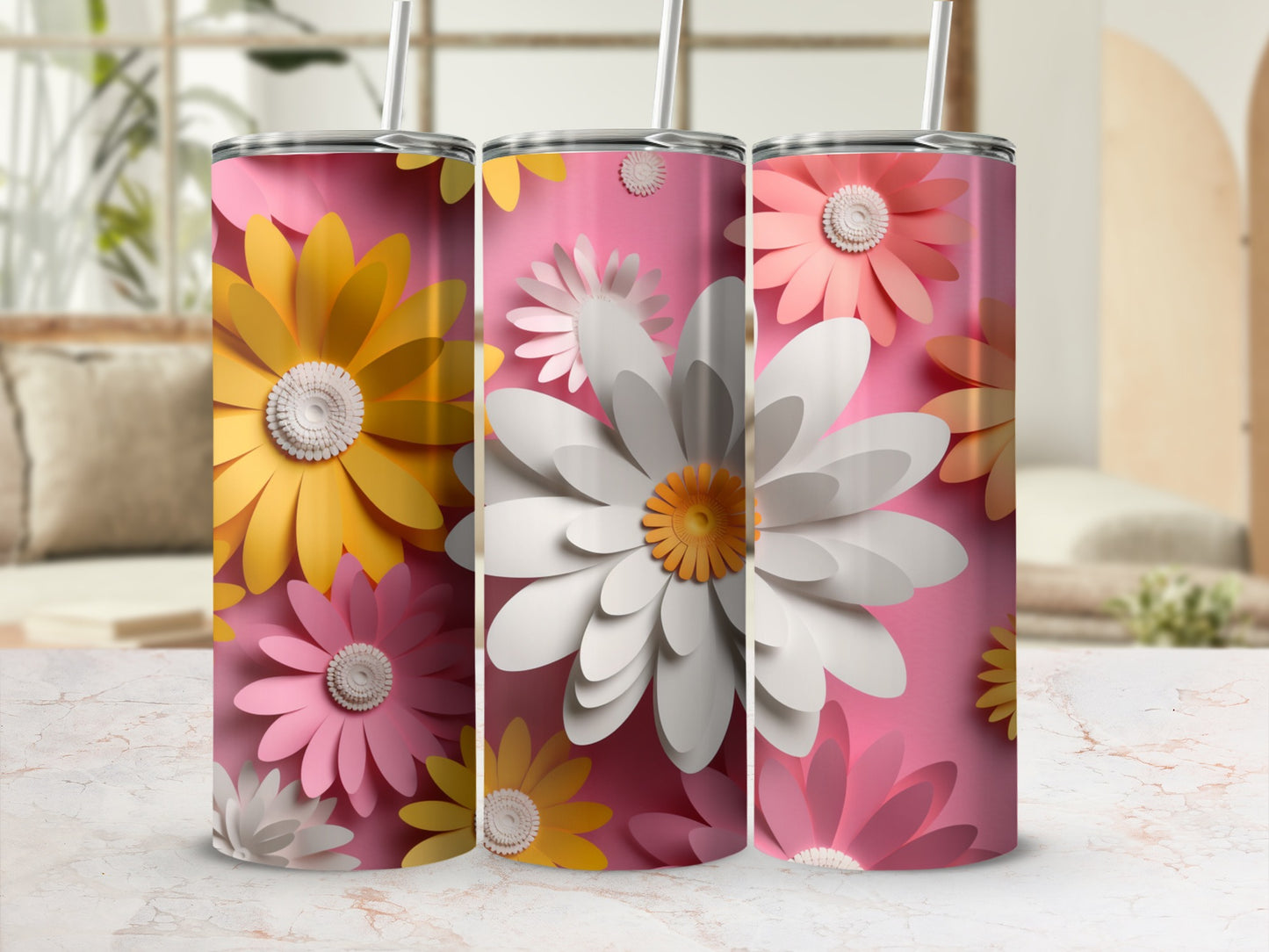 Three pink tumblers with large white and yellow paper flower designs.