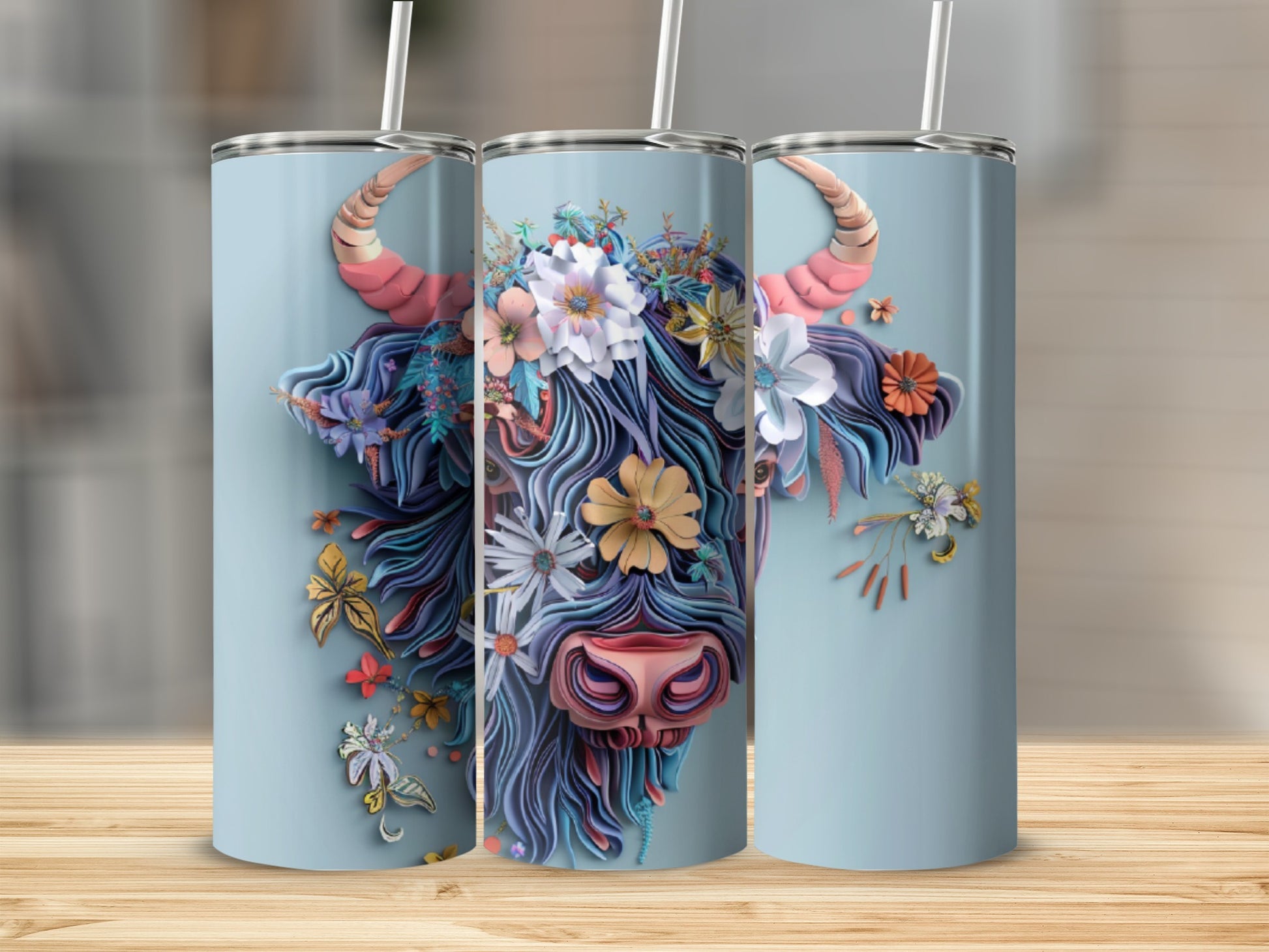 Floral Highland cow design on a light blue insulated tumbler.