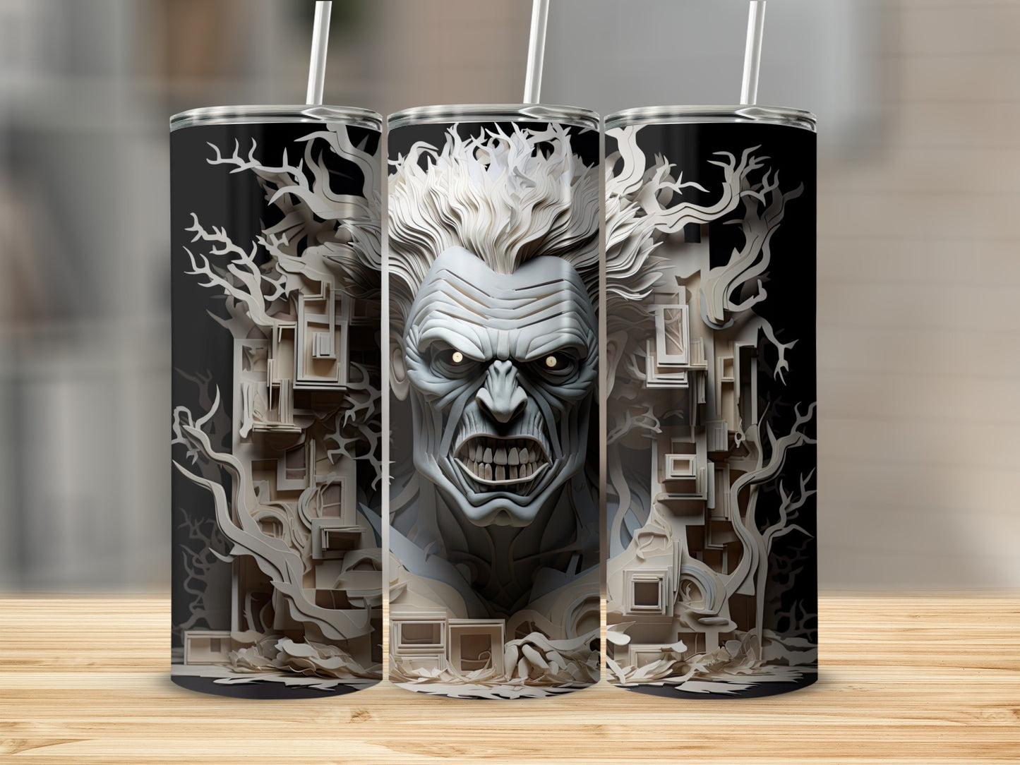 Three tumblers feature a monstrous face with glowing eyes and a forest of paper-cut trees.