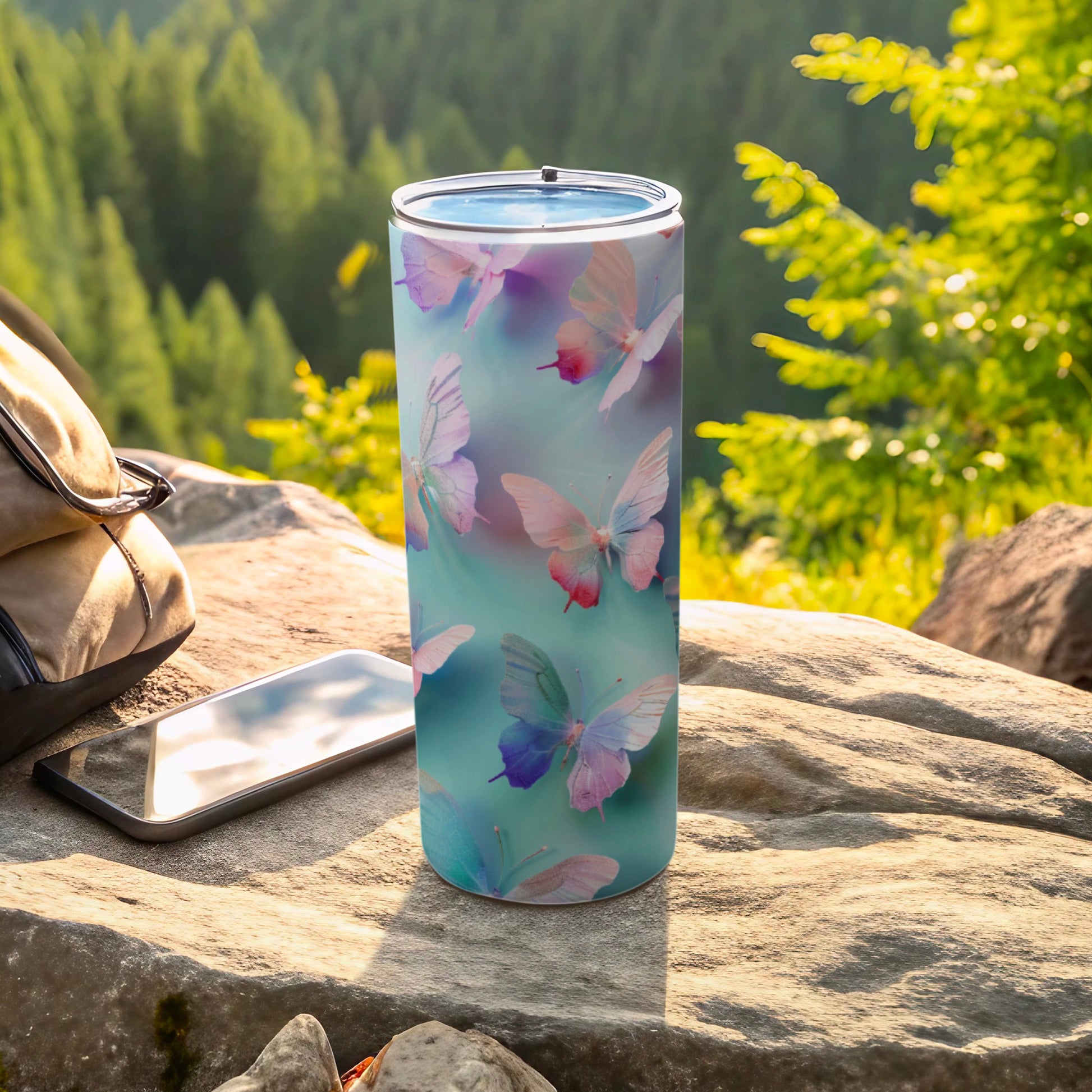 Tumbler with pastel butterflies and teal watercolor background.