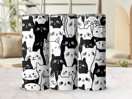 White tumbler with repeating pattern of black and white cartoon cats.
