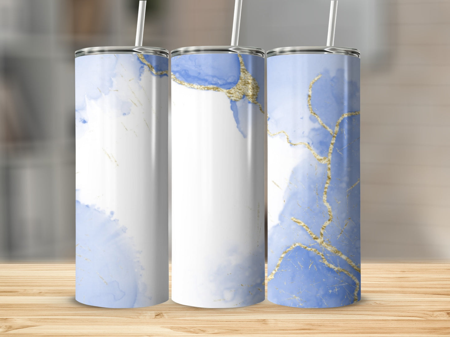Three tumblers with blue and white watercolor patterns and gold accents.