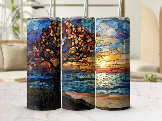 Three stained glass tumblers depicting a tree and seascape at sunset.