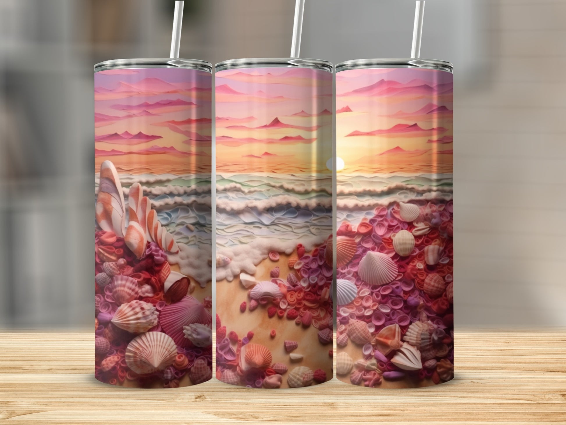 Three tumblers display a vibrant beach sunset with colorful seashells.