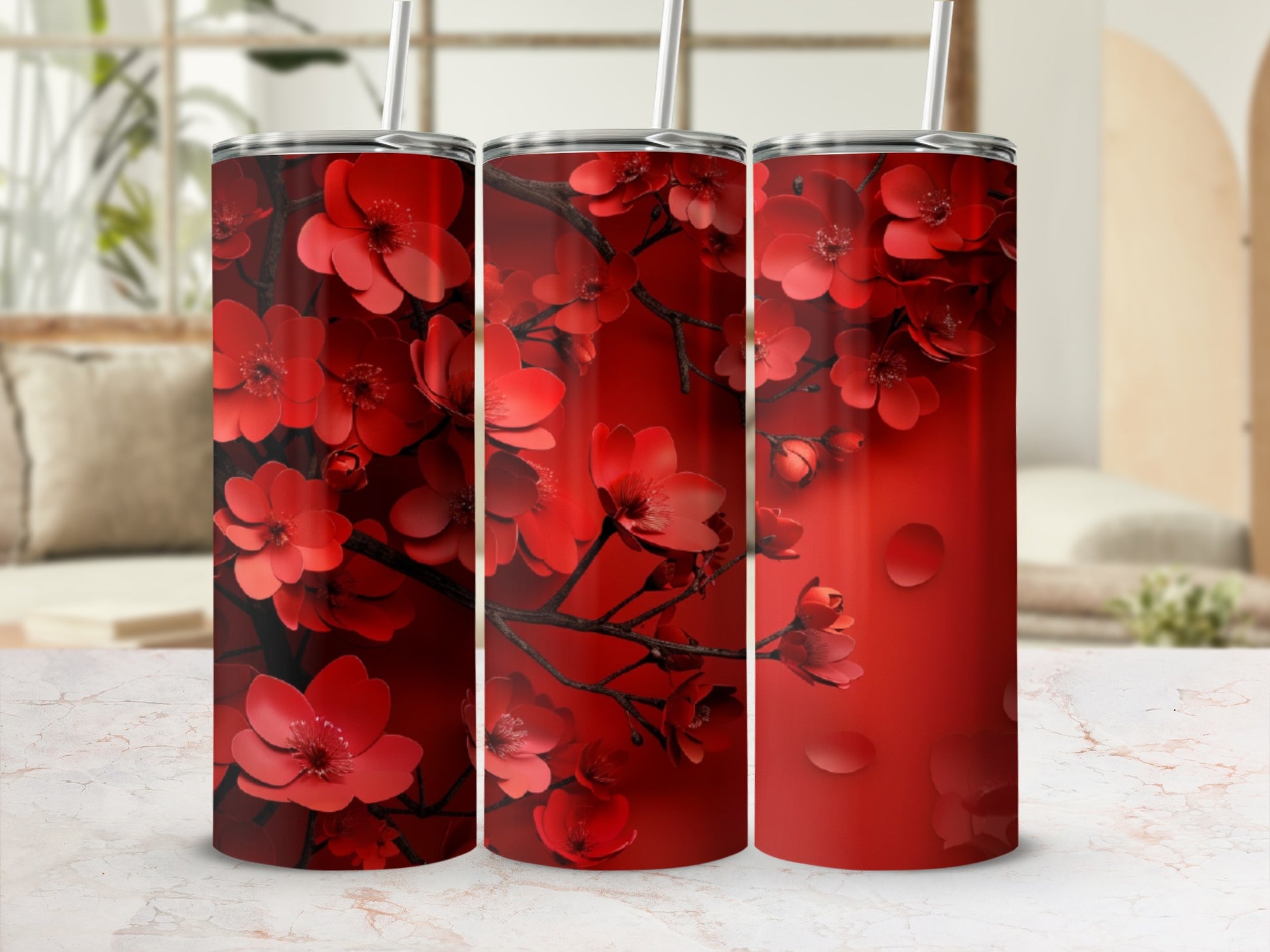 Red floral pattern on a tall, slim tumbler with a straw.
