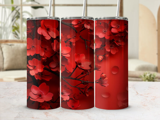 Red floral pattern on a tall, slim tumbler with a straw.