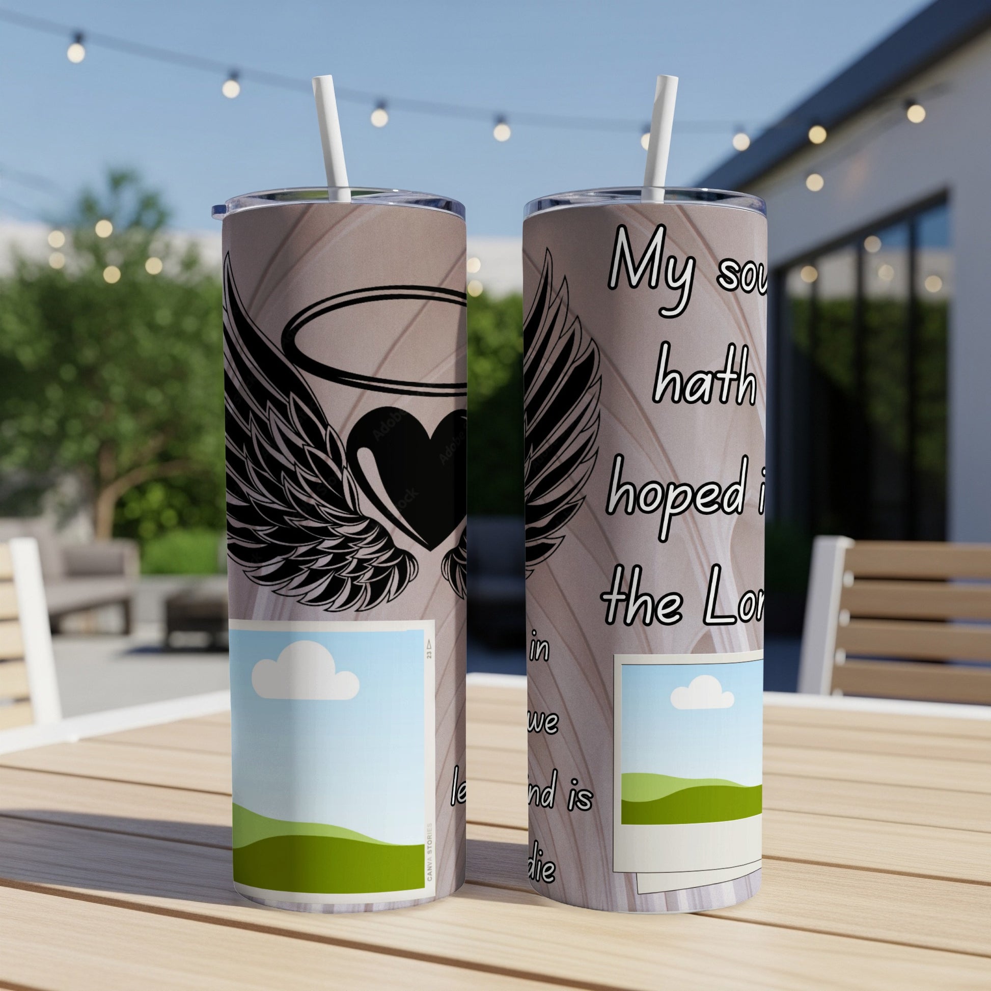 Two tumblers with winged heart and scripture text on a wooden table.