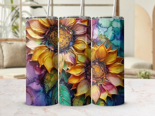 Three tumblers with colorful sunflower designs on a marbled surface.