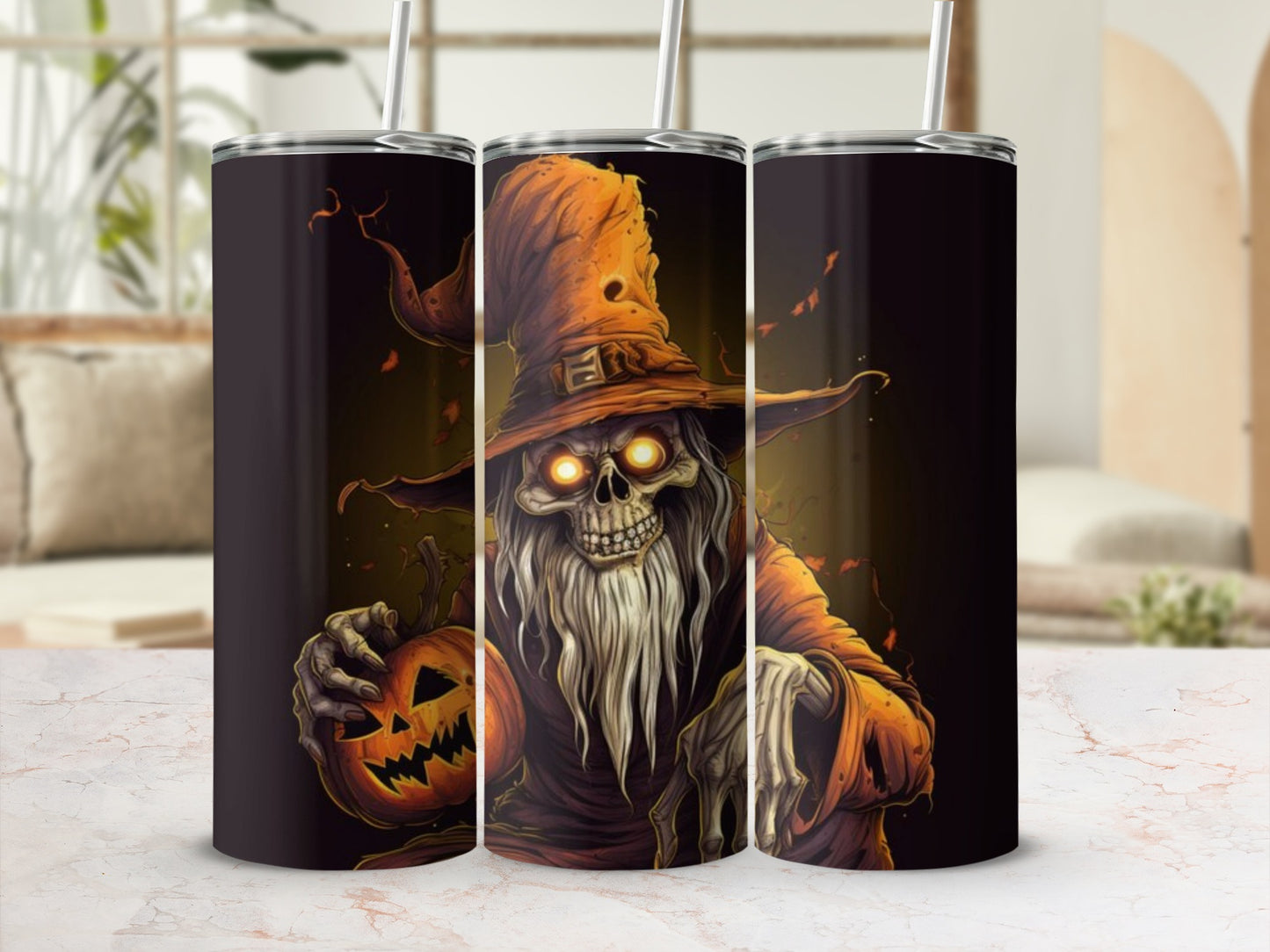 Three tumblers with a Halloween skeleton wizard design holding a jack-o-lantern.