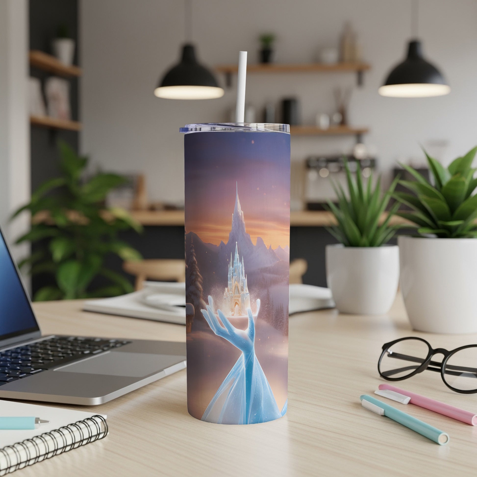Tumbler with castle and icy hand design, on a desk.