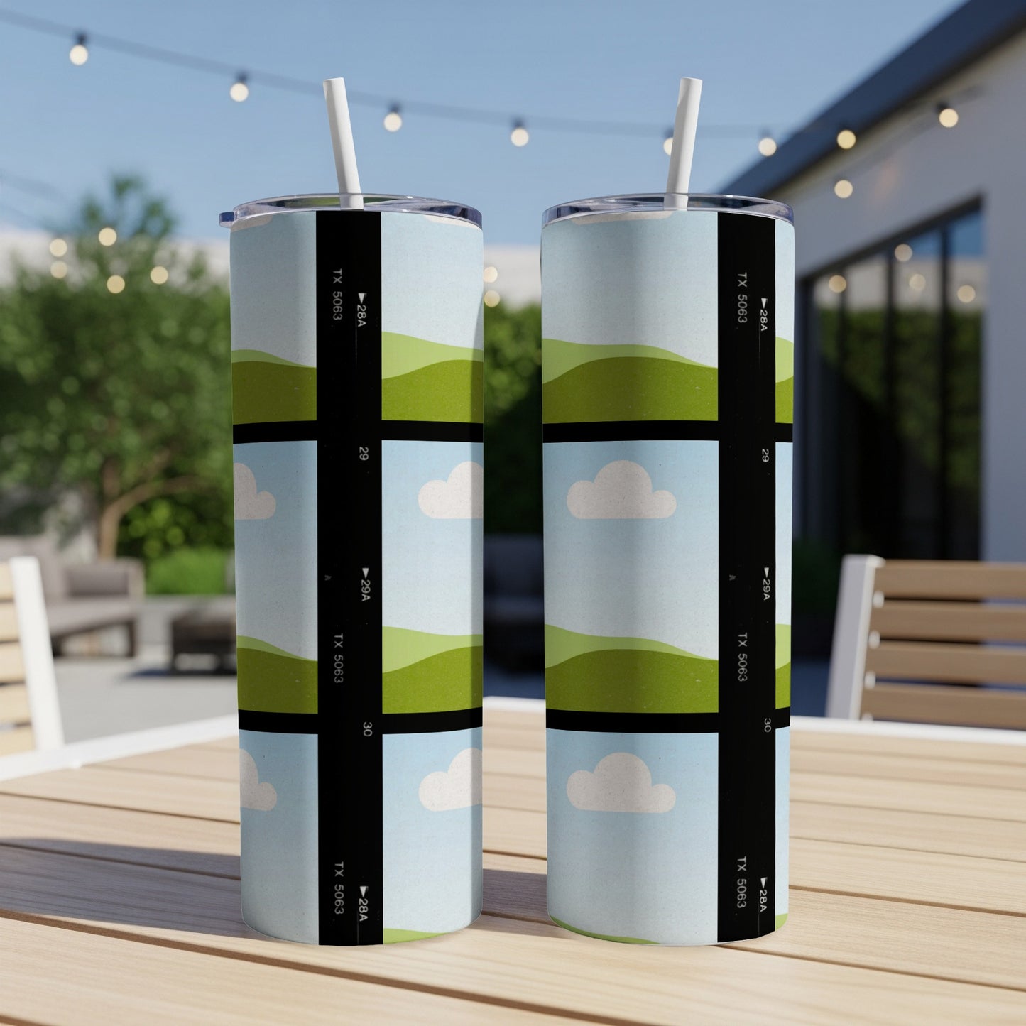 Two tumblers with a film strip design of rolling green hills and clouds.
