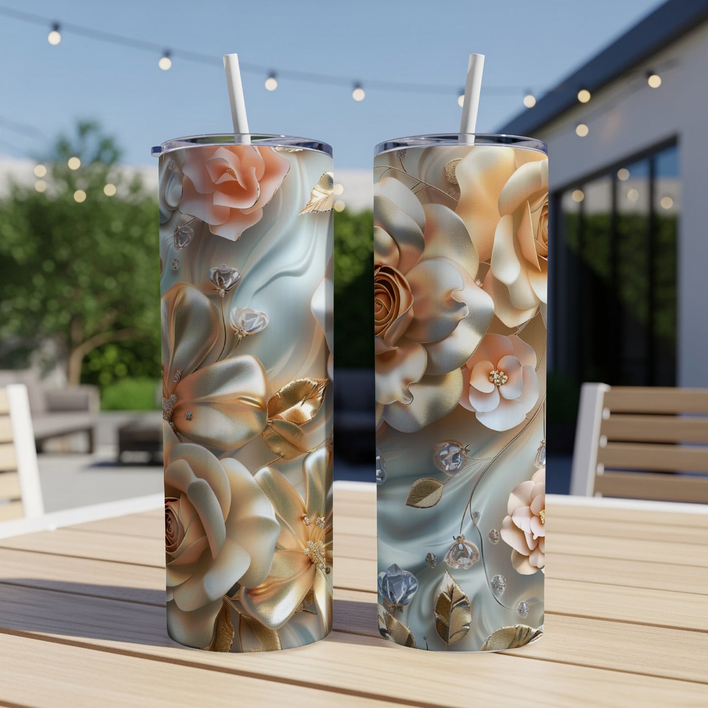 Two tall floral tumblers with gold and rose details sit on a table.