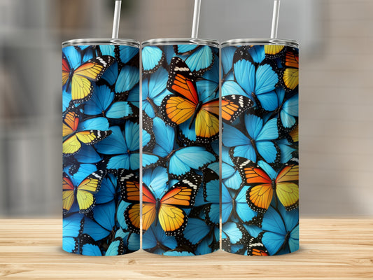 Tumbler with a repeating pattern of colorful blue and orange butterflies.