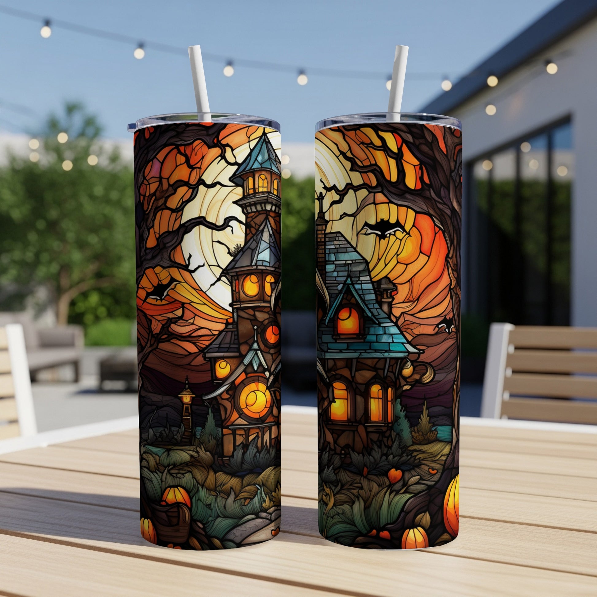 Halloween haunted house design on two tumblers.