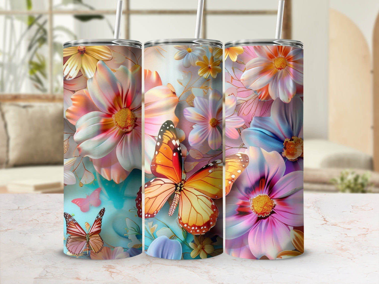 Three tumblers with colorful floral and butterfly designs.
