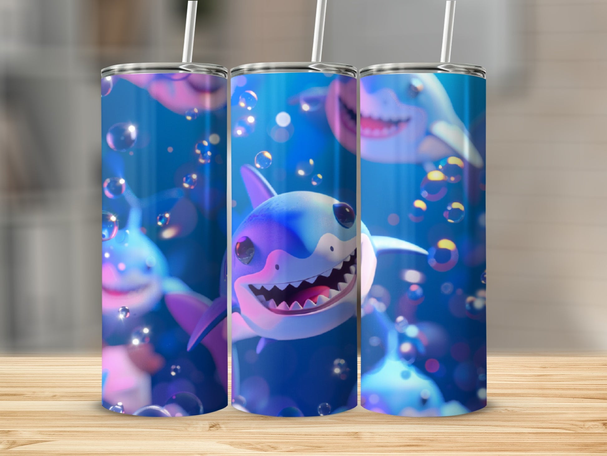 Three tumblers with cartoon sharks and bubbles, on a wooden surface.