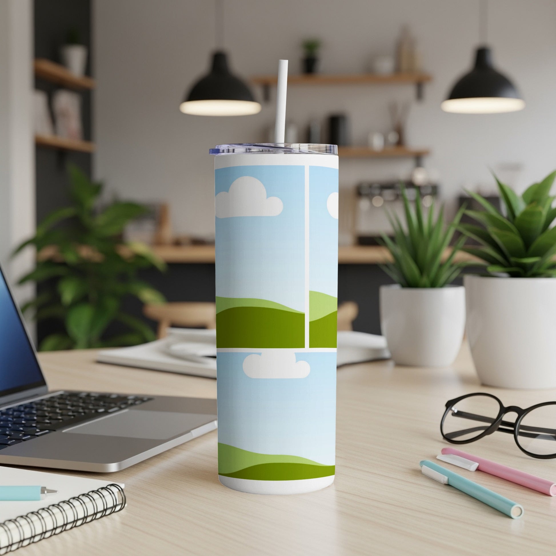 White tumbler with cartoon clouds and green rolling hills design.