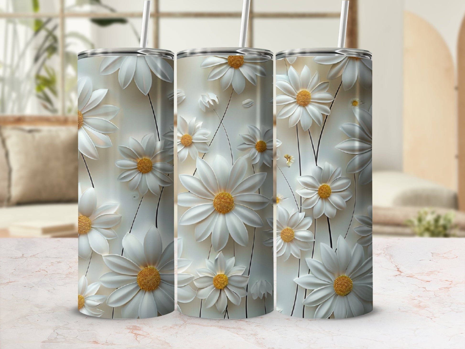 Three tumblers with white daisy floral designs and gold centers.