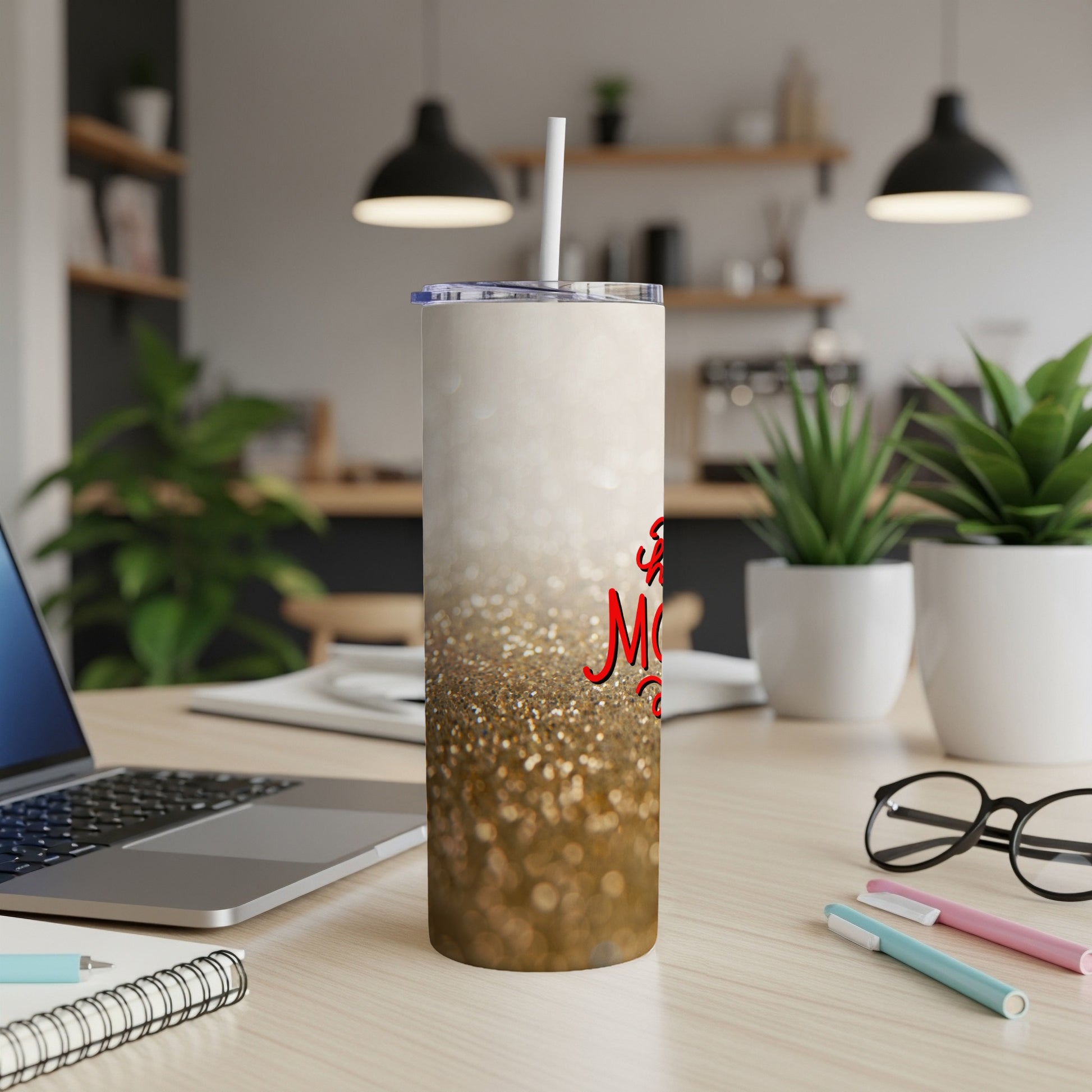 Sparkle tumbler with "Best Mom Ever" text on a desk with a laptop.